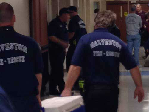 Galveston firefighters stand by in the hallways...